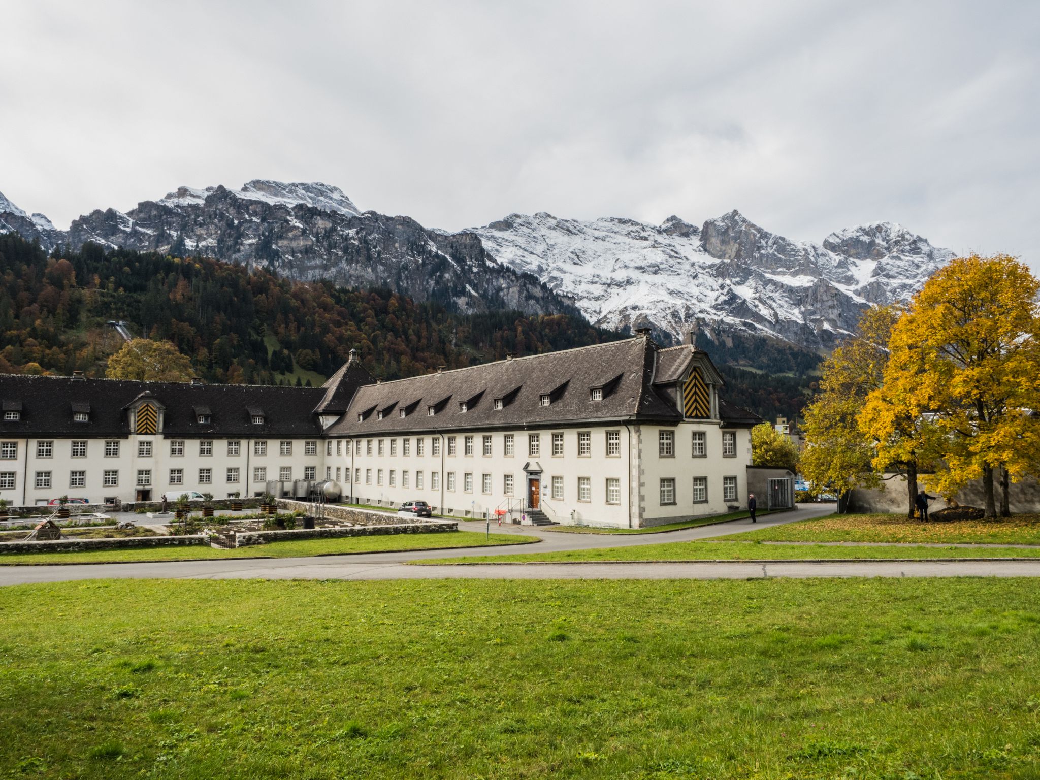 photo of Engelberg Abbey with beautiful alps in the background wide view in Switzerland.