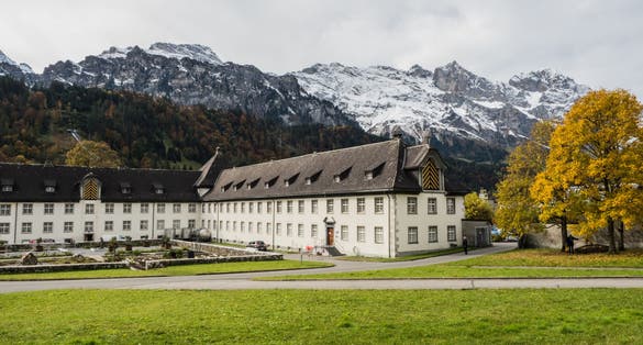 photo of Engelberg Abbey with beautiful alps in the background wide view in Switzerland.
