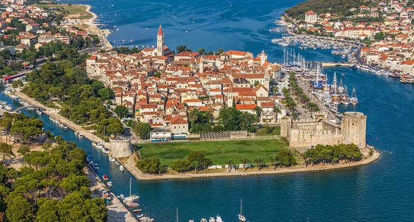 Photo of aerial view of Trogir old town panorama with Kamerlengo Castle in front. Croatian tourist destination.