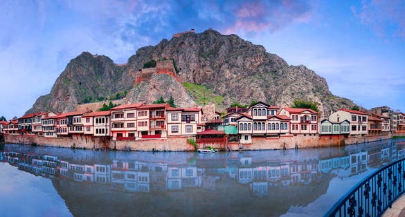 Amasya,TURKEY old riverside Turkish(ottoman) city buildings and its reflection on water,sunny summer day.Amasya is city of princes of ottoman. ottoman Princes were educated in Amasya