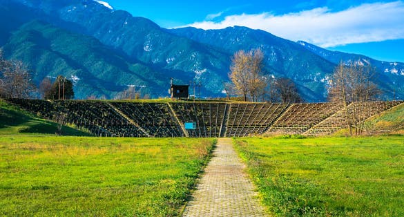 photo of View of Hellenistic Theater at the archaeological site of Dion situated in the northern foothills of Mount Olympus. Pieria, Macedonia, Greece.