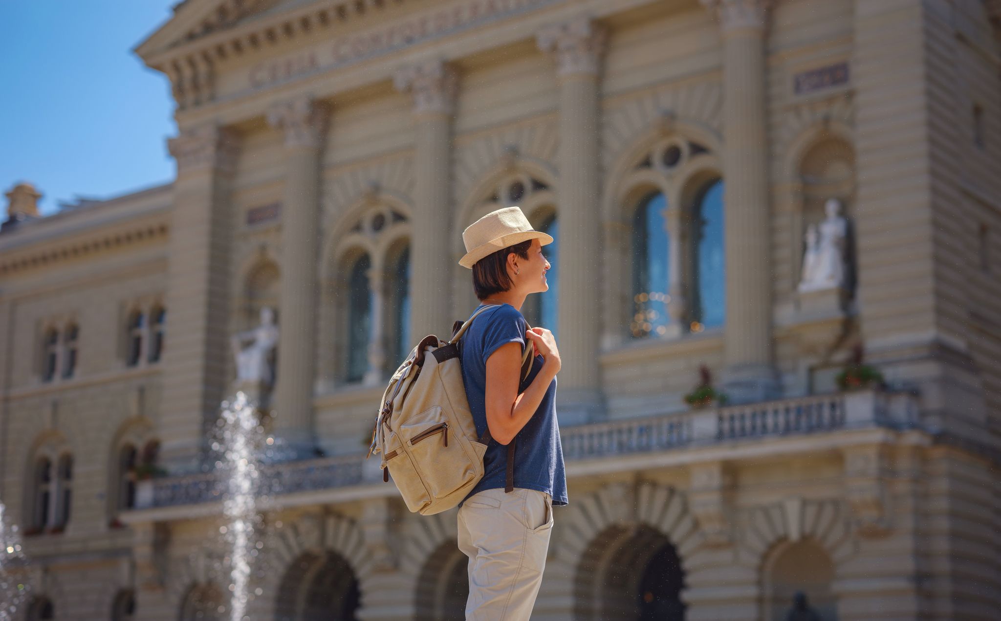 photo of woman having a great vacation in Switzerland, Bern, visiting Federal Palace of Switzerland.