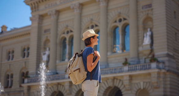 photo of woman having a great vacation in Switzerland, Bern, visiting Federal Palace of Switzerland.