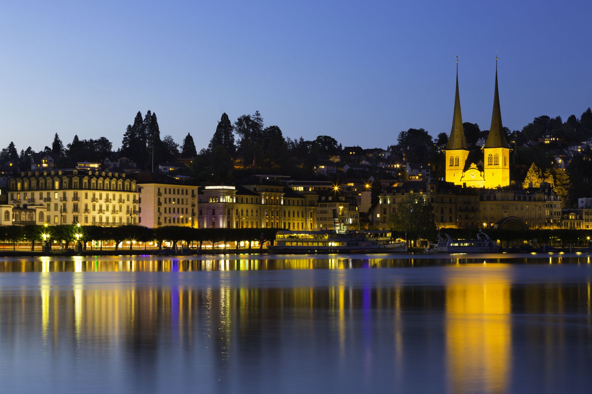 photo of Lake Lucerne and City Skyline with St. Leodegar church at nighttime Lucerne, Switzerland.