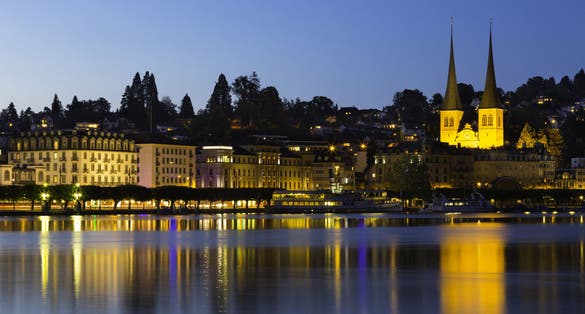 photo of Lake Lucerne and City Skyline with St. Leodegar church at nighttime Lucerne, Switzerland.