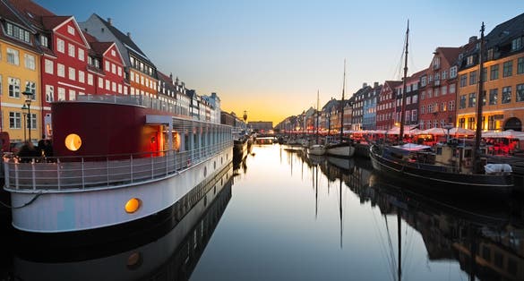 Photo of Ships in Nyhavn at beautiful sunset, Copenhagen, Denmark.