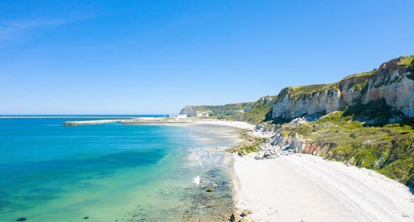 Photo of The verdant Norman Cliffs above the white pebble beach in Europe, France