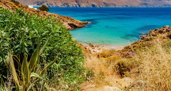 photo of view of The hidden and lonely beach of Agios Sostis, is not equipped with umbrellas and deck chairs, it is protected on windy days, it is a fairly unspoiled place. Mykonos, Cyclades islands, Aegean sea, Greec,Laganas greece.