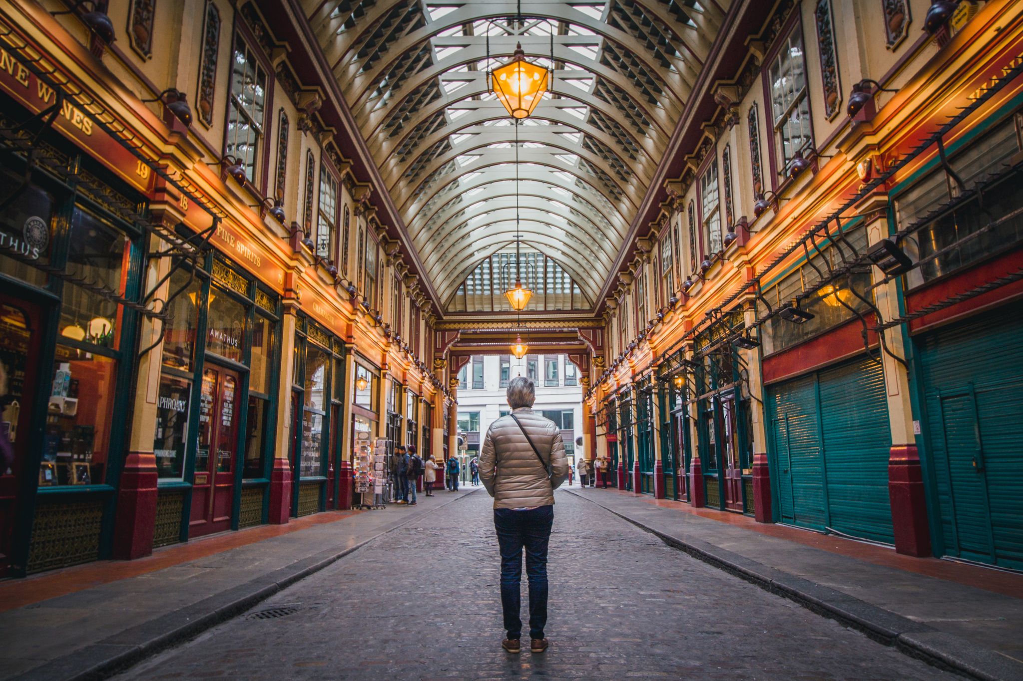 Photo of a man looking at Leadenhall Market in London, UK.