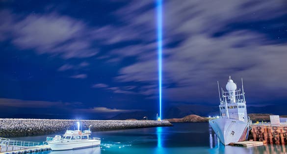photo of view of The Imagine Peace Tower on Videy island in Reykjavik, Iceland.