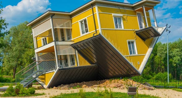 Tagurpidi Maja - a yellow house flipped upside down in Estonain town Tartu.