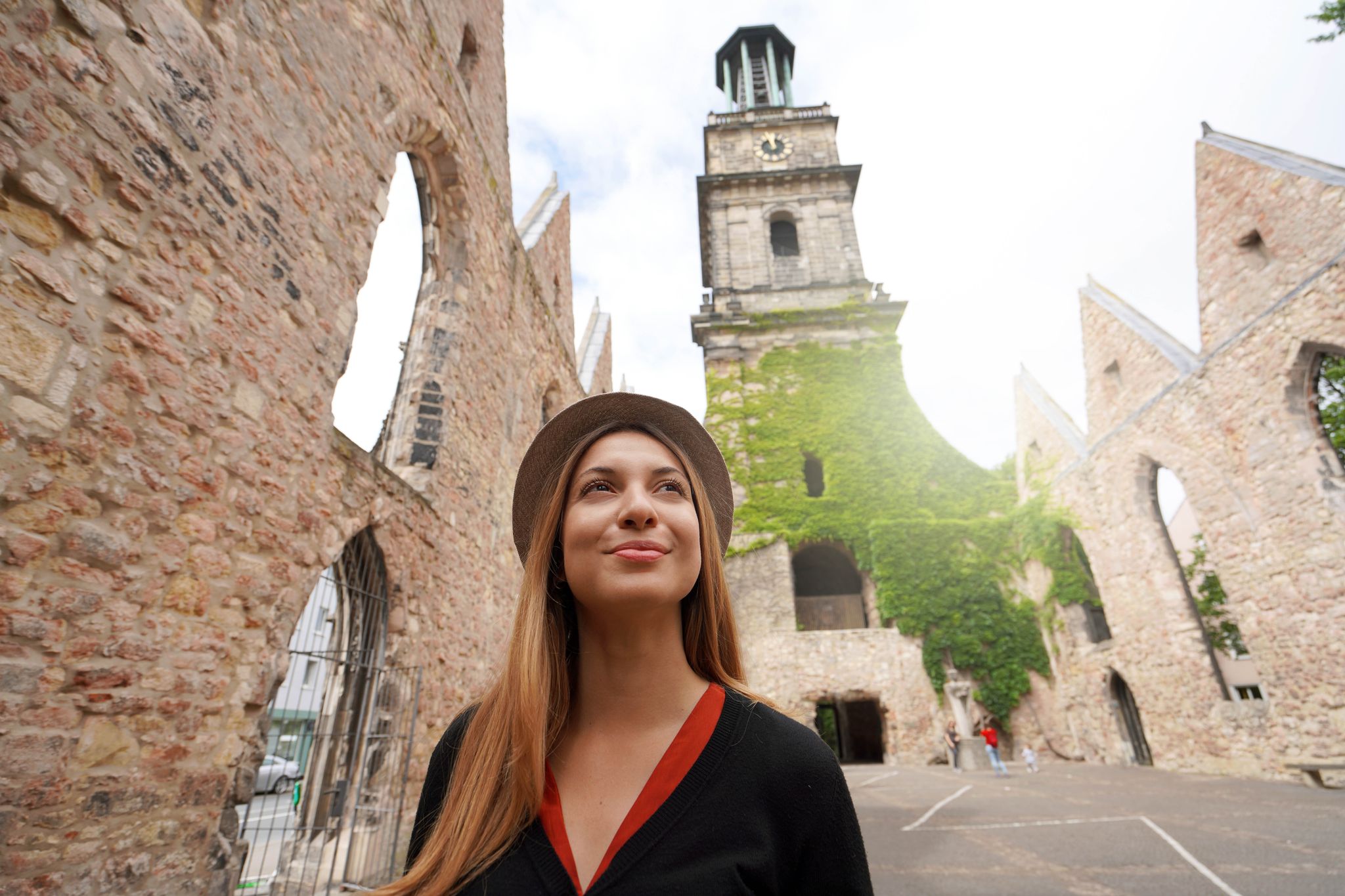 Portrait of tourist girl visiting the ruins of the church of Aegidienkirche in Hanover, Germany