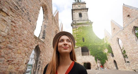 Portrait of tourist girl visiting the ruins of the church of Aegidienkirche in Hanover, Germany