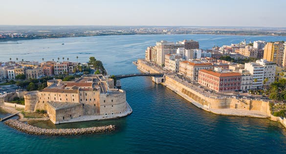 Beautiful panoramic aerial view photo from flying drone on Old medieval Aragonese Castle on sea channel, old town of Taranto city, Puglia (Apulia), Italy (Series)