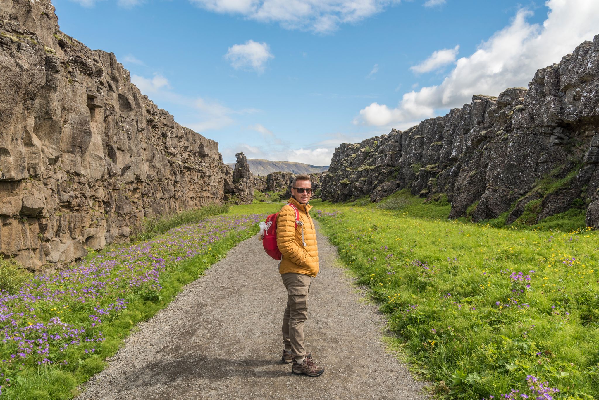 photo of Caucasian hiker on the hiking route between Lögberg and Drekkingarhylur in amazing Iceland. Geology, volcanic, summer, tourist, tourism, destination, visit, europe, nordic, north, golden circle.