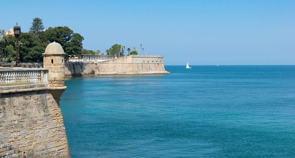 photo of Cadiz Walls of San Carlos and Baluarte de la Candelaria. With the blue sea and sky. Andalusia, Spain.