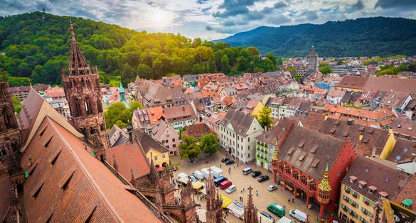 photo of view of Aerial view of the historic city center of Freiburg im Breisgau from famous old Freiburger Minster in beautiful evening light at sunset with blue sky and clouds in summer, Baden-Wurttemberg, Germany,Freiburg im Breisgau Germany.