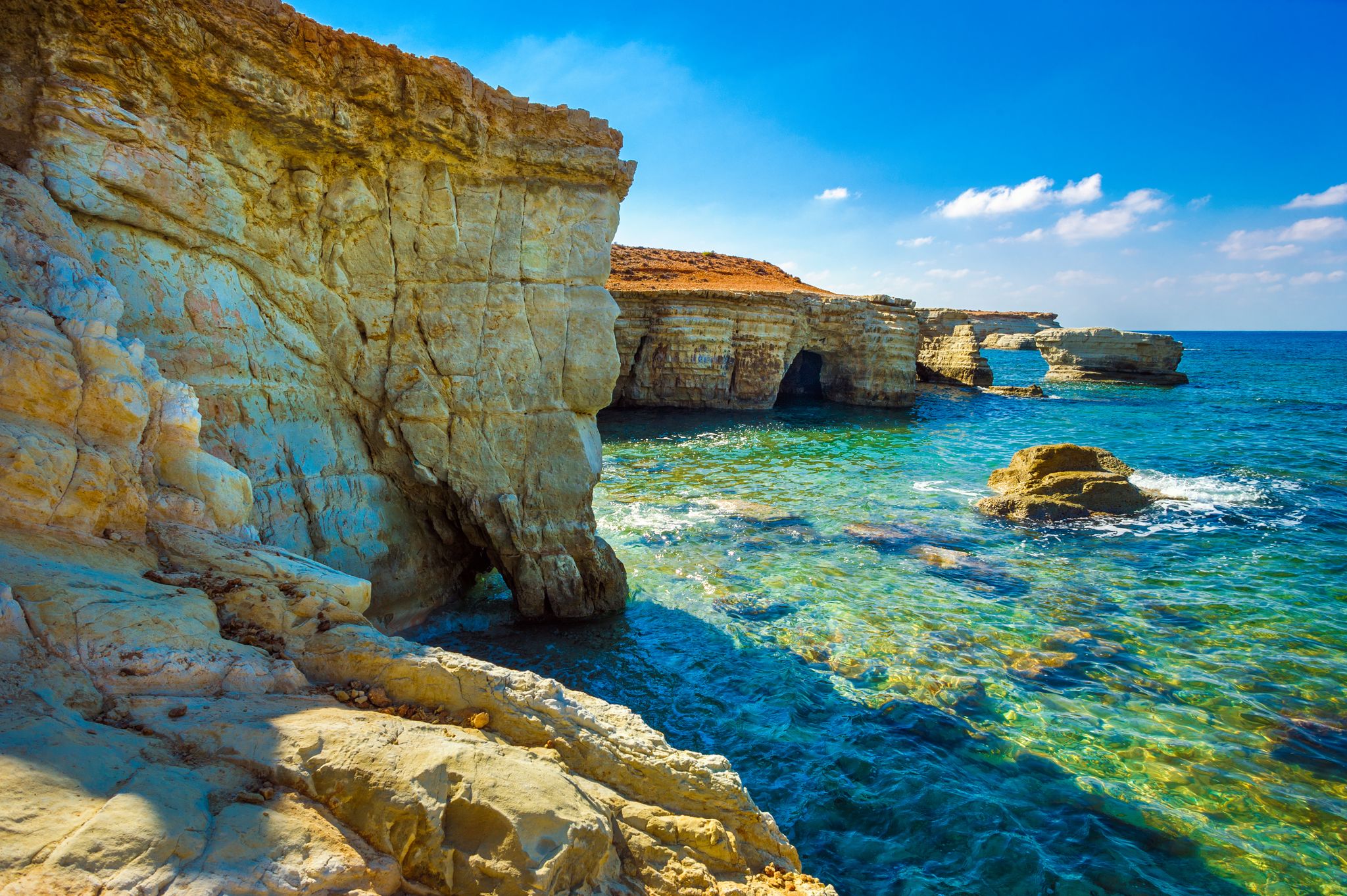 Photo of sea caves on Coral bay coastline, Paphos district, Cyprus.