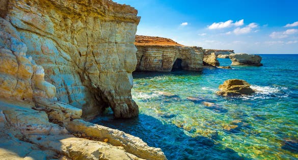 Photo of sea caves on Coral bay coastline, Paphos district, Cyprus.