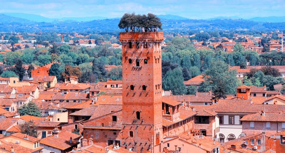 photo of Lucca, Italy - medieval town of Tuscany. Aerial view with Guinigi Tower.