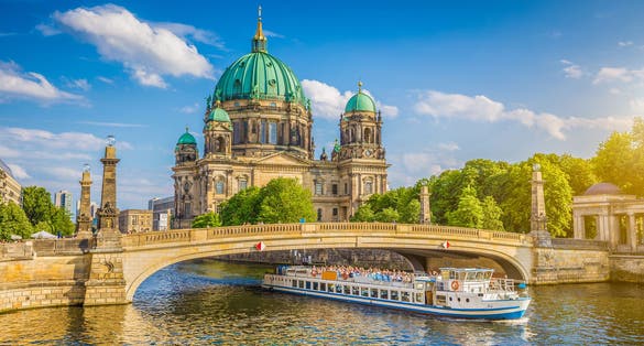beautiful view of historic Berlin Cathedral (Berliner Dom) at famous Museumsinsel (Museum Island) with excursion boat on Spree river in beautiful sunset in summer, Berlin.