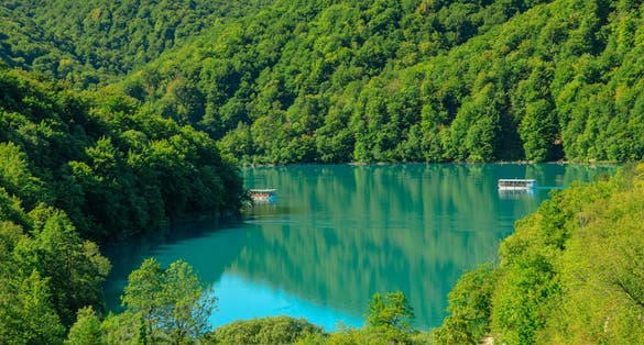Kozjak lake with ferry boats overlook on Plitvice Lakes National Park of Croatia. Natural forest park with lakes and waterfalls in Lika region. UNESCO World Heritage of Croatia named Plitvicka Jezera