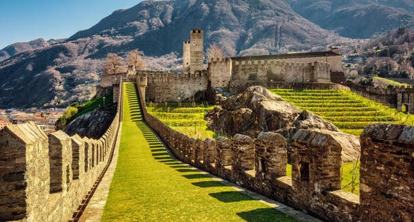 photo of walls and towers of Castelgrande castle in Bellinzona city in the Alps mountains, Ticino, Switzerland.