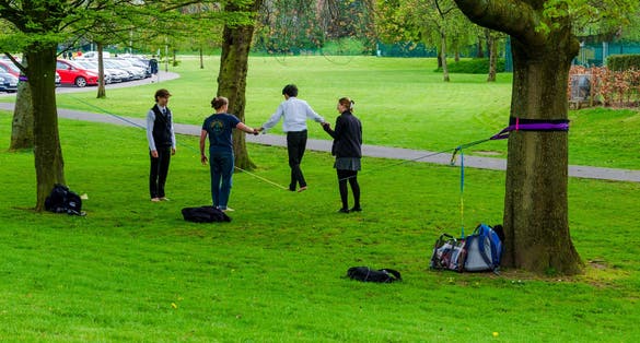 People practicing tightrope walking in Botanic Gardens in Belfast County Down.