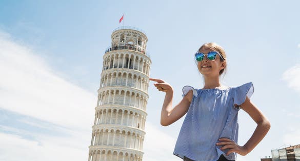 photo of happy child girl pointing leaning tower of pisa.