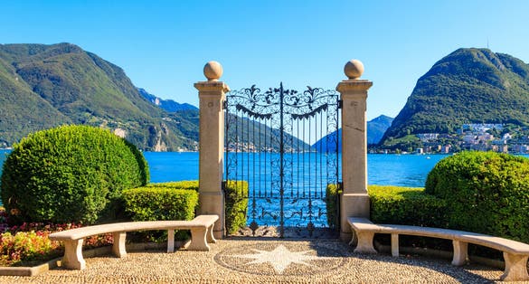 Photo of Old wrought iron gate overlooking Lake Lugano in Ciani Park, Lugano, Switzerland.