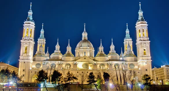 Photo of Our Lady of the Pillar Basilica as seen from the north shore at night of Ebro River at Zaragoza, Spain