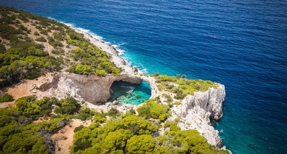 Photo of aerial view of seals cave and beautiful beach in Loutraki ,Greece.
