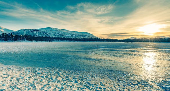 It was 1pm when we took this shot on the frozen Prestvannet Lake in Tromsø. The sun was high in the sky! The colors were magical...
