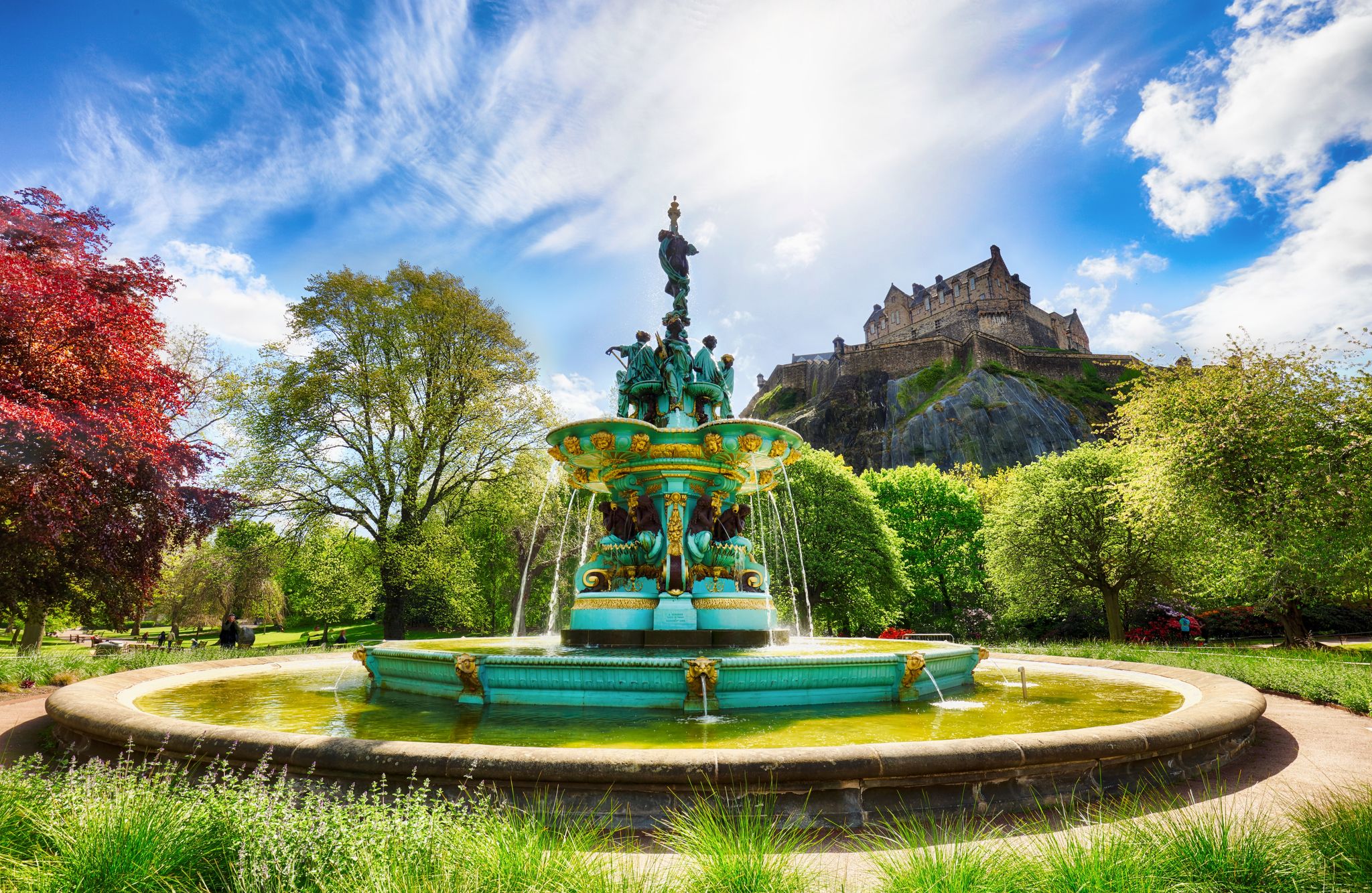 Edinburgh Castle in blue sky, sun and clouds and Ross Fountain.jpg