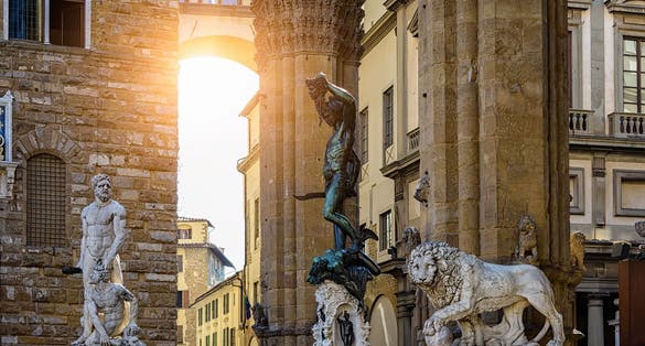 photo of view of Sculpture of Loggia dei Lanzi and Florence Palazzo Vecchio on Piazza della Signoria in Florence, Italy.