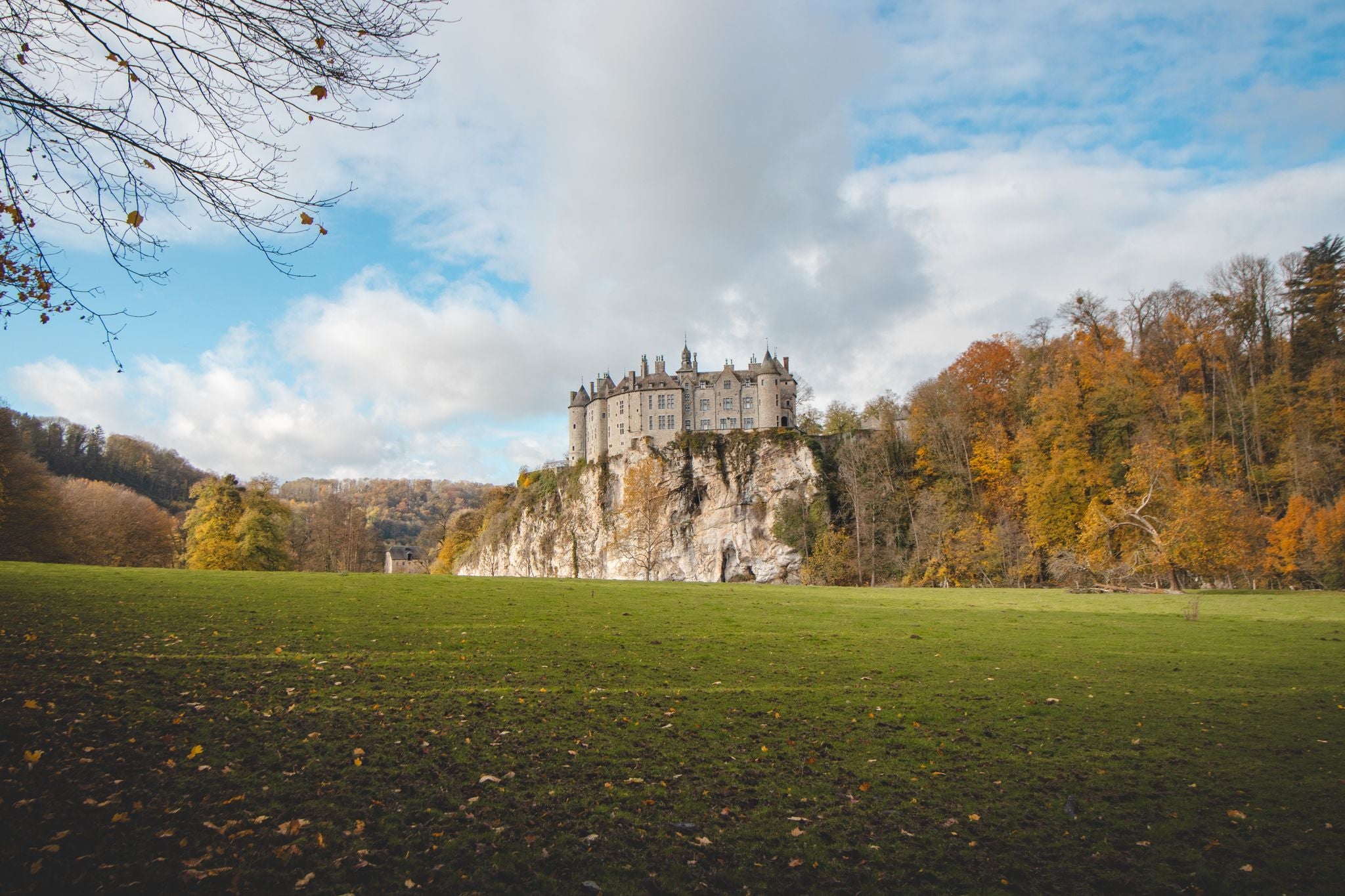 photo of view of Medieval Walzin Castle on the banks of the River Lesse in the Wallonia region of southern Belgium. Gothic Revival castle stands on a steep rock in the province Namur. 