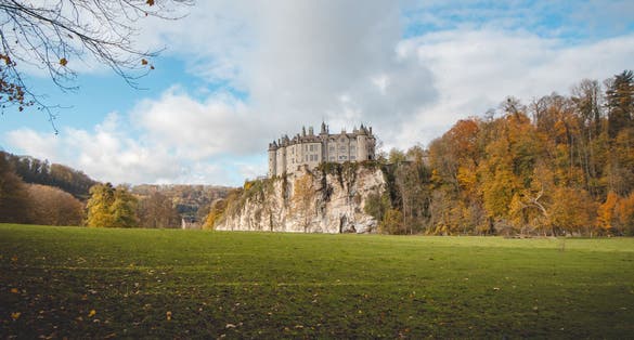 photo of view of Medieval Walzin Castle on the banks of the River Lesse in the Wallonia region of southern Belgium. Gothic Revival castle stands on a steep rock in the province Namur. 