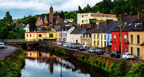 Photo of beautiful landscape in Donegal, Ireland with river and colorful houses.