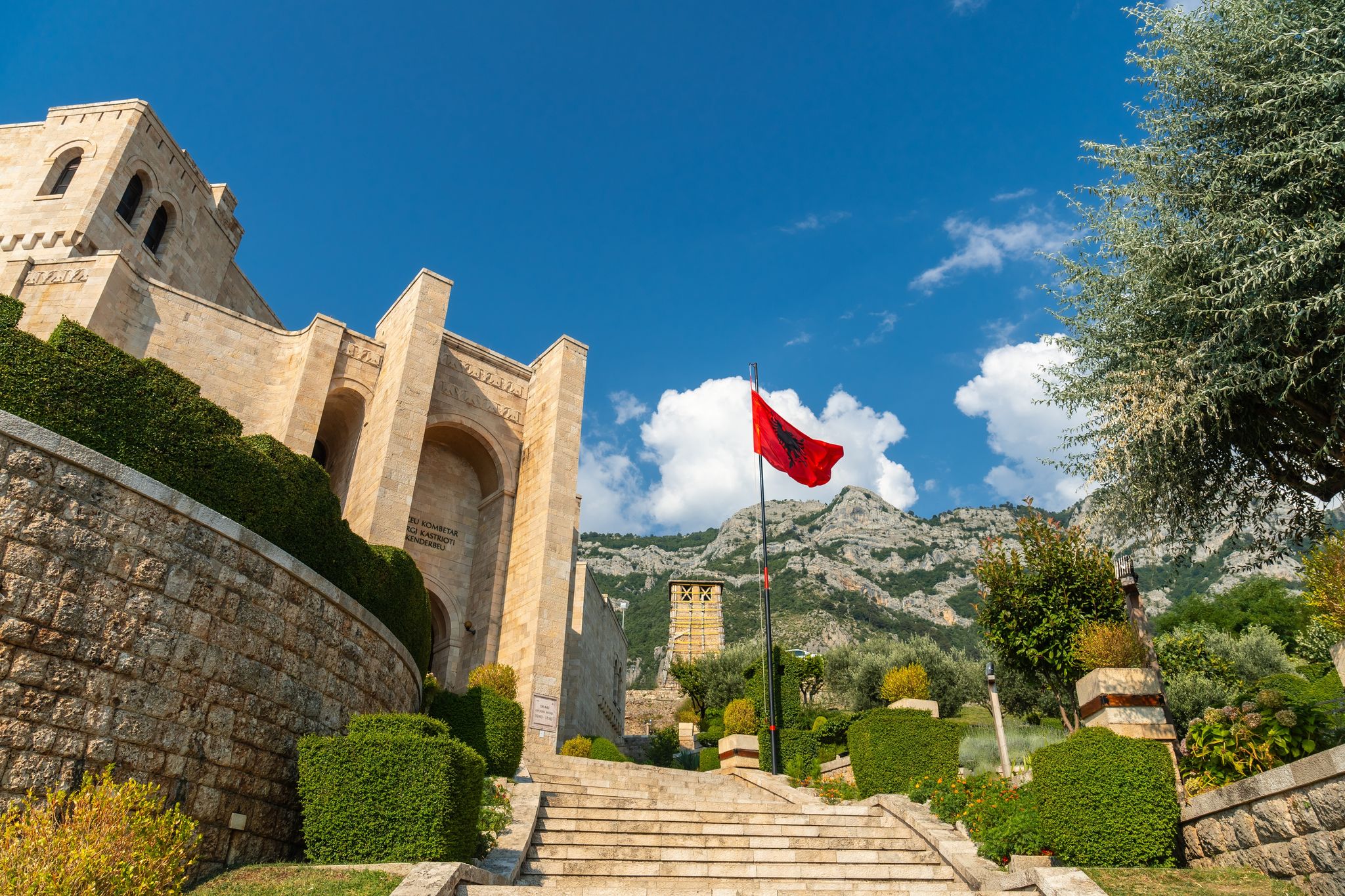 Photo of stairs inside Kruje Castle and its fortress with the walls and mountains in the background, Albania.