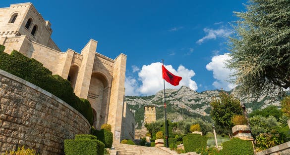 Photo of stairs inside Kruje Castle and its fortress with the walls and mountains in the background, Albania.
