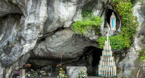 Photo of statue of Virgin Mary in the grotto of Lady of Lourdes, France.