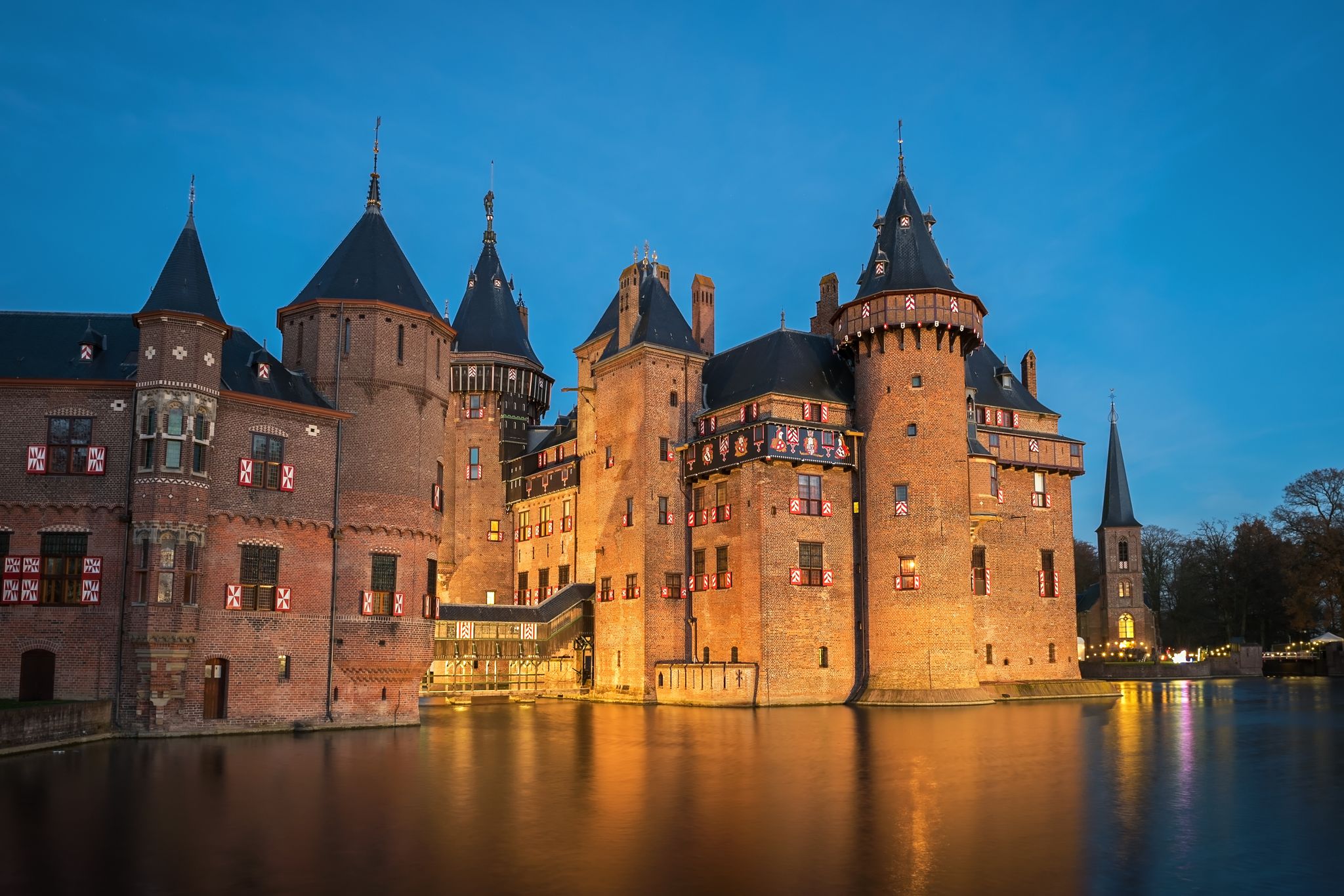 Photo of the medieval castle De Haar in the evening illumination, The Netherlands.