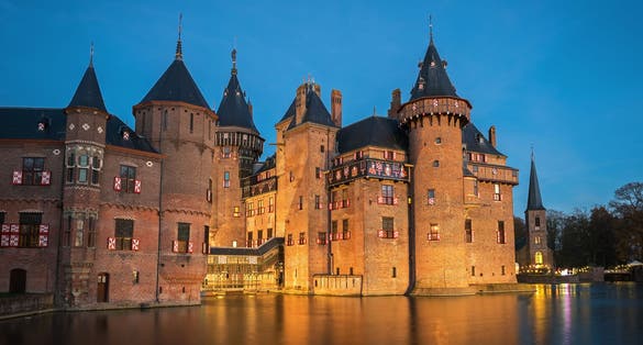 Photo of the medieval castle De Haar in the evening illumination, The Netherlands.