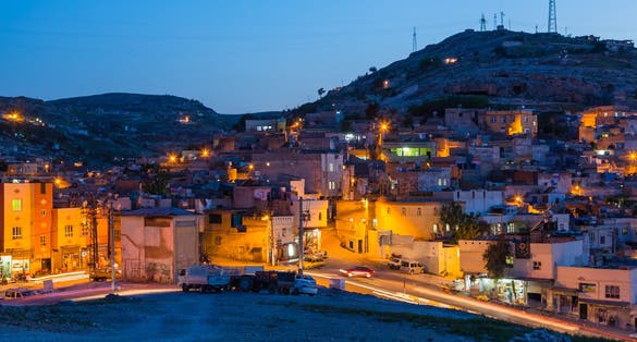 PHOTO OF VIEW OF The night view of the old city seen from the hill of Şanlıurfa, Turkey.