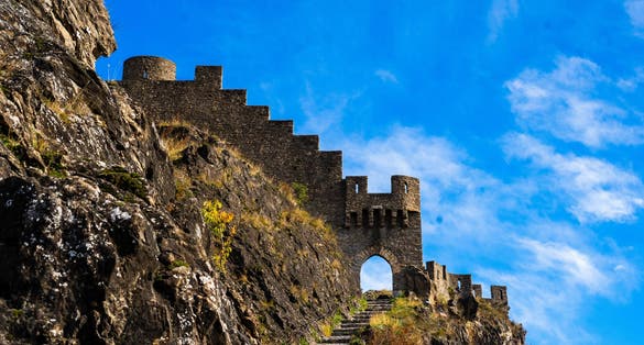 Entrance door and wall of the ruins of Photo of Tourbillon castle and Sion hill and city panorama in background in Sion Valais Switzerland