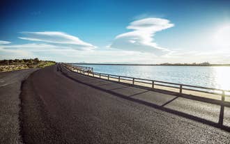 Photo of Beach seashore with wooden path to sea water in San Pedro del Pinatar