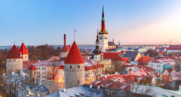 Photo of aerial cityscape with Medieval old town, St. Olaf Baptist Church and Tallinn city, Estonia.