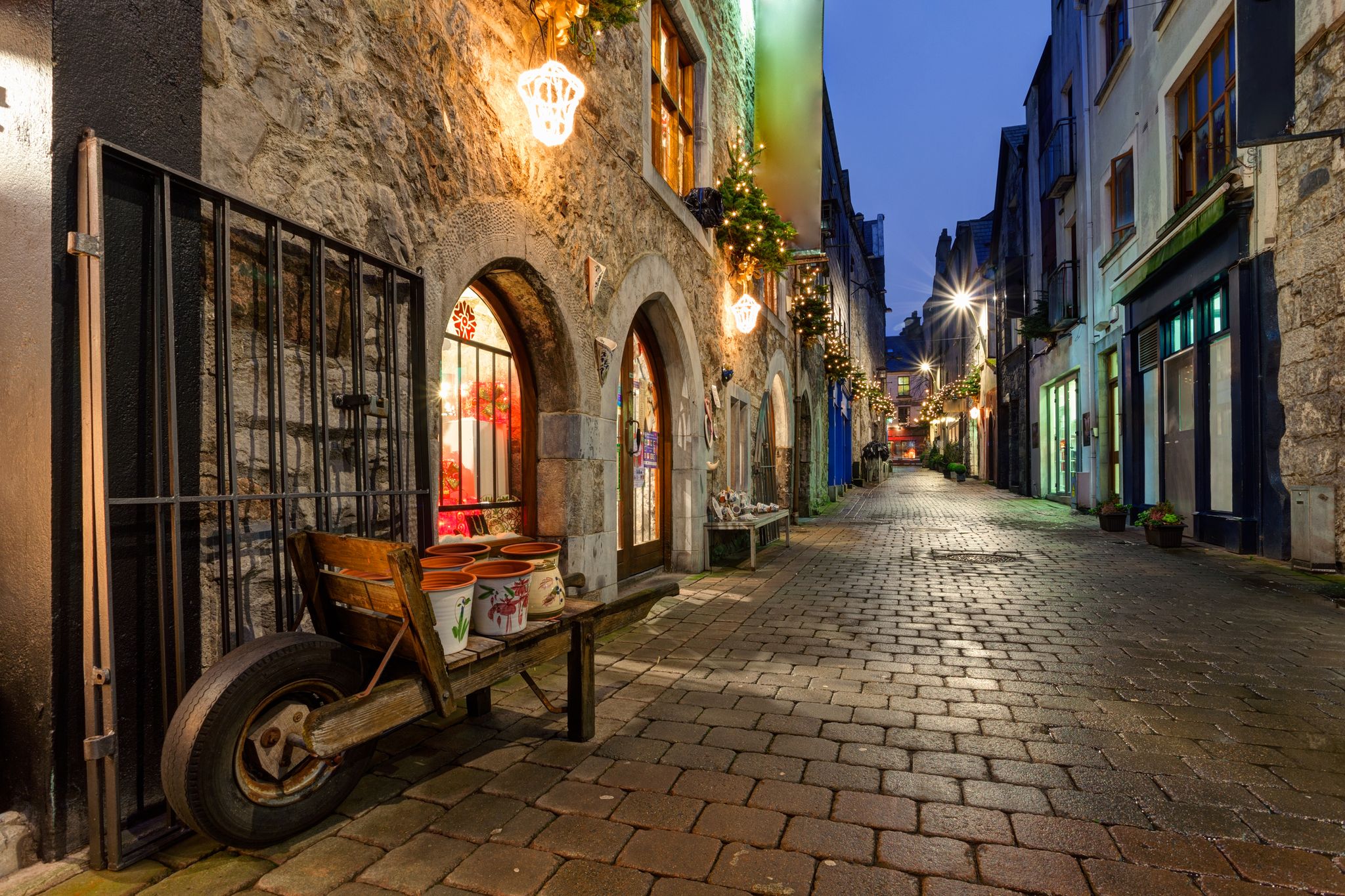 photo of view of Old street in Galway, Kerwan's Lane, decorated with christmas lights, night scene.