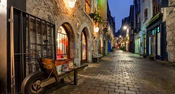 photo of view of Old street in Galway, Kerwan's Lane, decorated with christmas lights, night scene.
