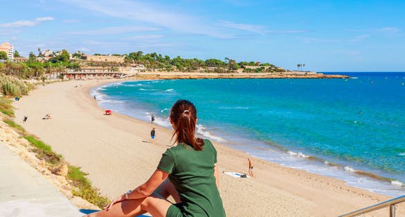Tourist woman in Tarragona, Spain, Europe. Beach and blue sea.
